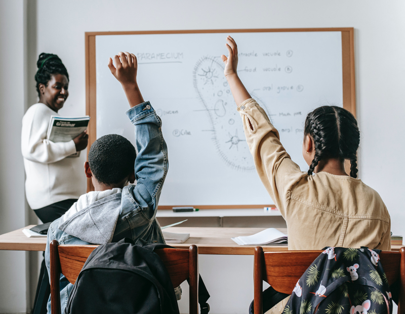 teacher with students in a classroom