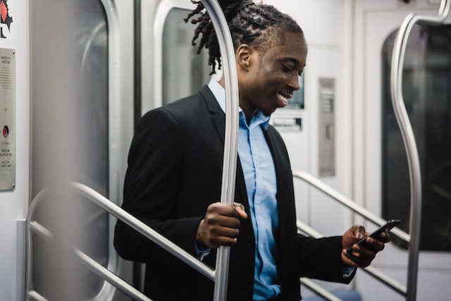 Man on train using smartphone